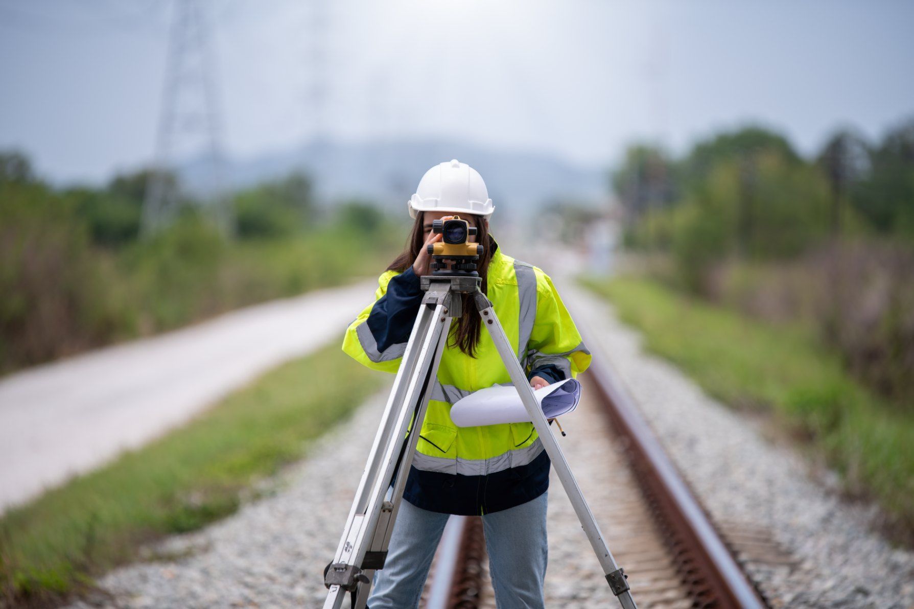 A Woman is Standing on Train Tracks Taking a Picture With a Camera — Western Survey Pty Ltd In Dubbo, NSW