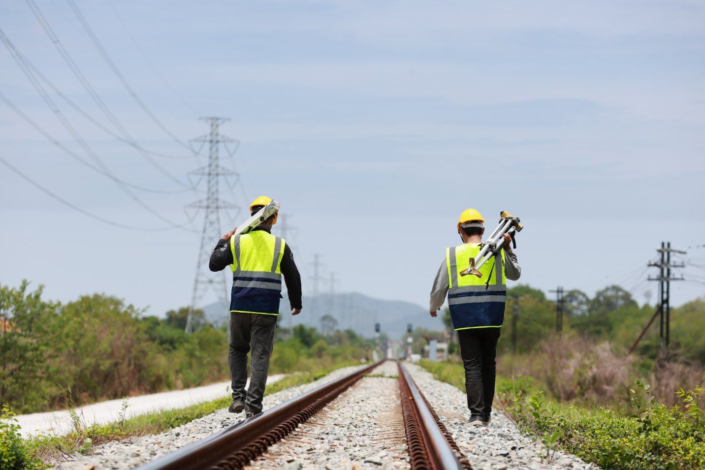 Two Construction Workers Are Walking on Train Tracks — Western Survey Pty Ltd In Dubbo, NSW