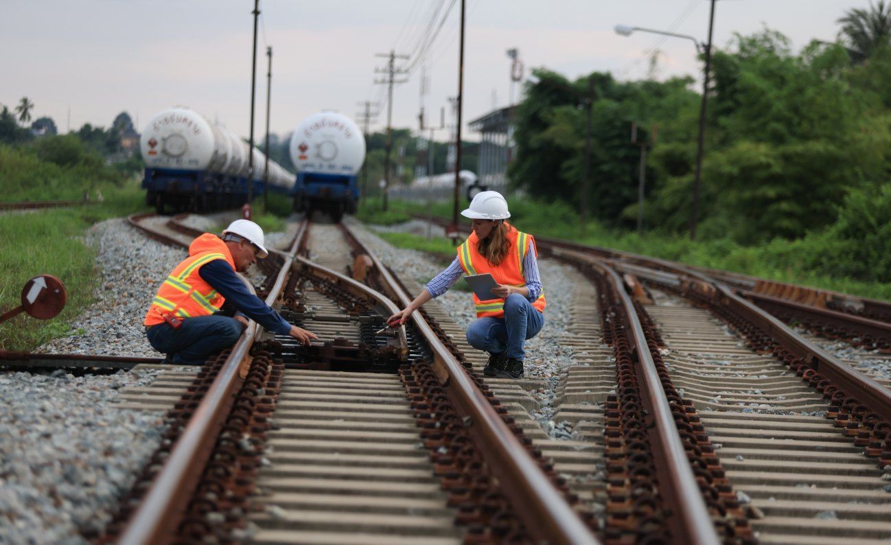 A Man and a Woman Are Working on Train Tracks — Western Survey Pty Ltd In Dubbo, NSW