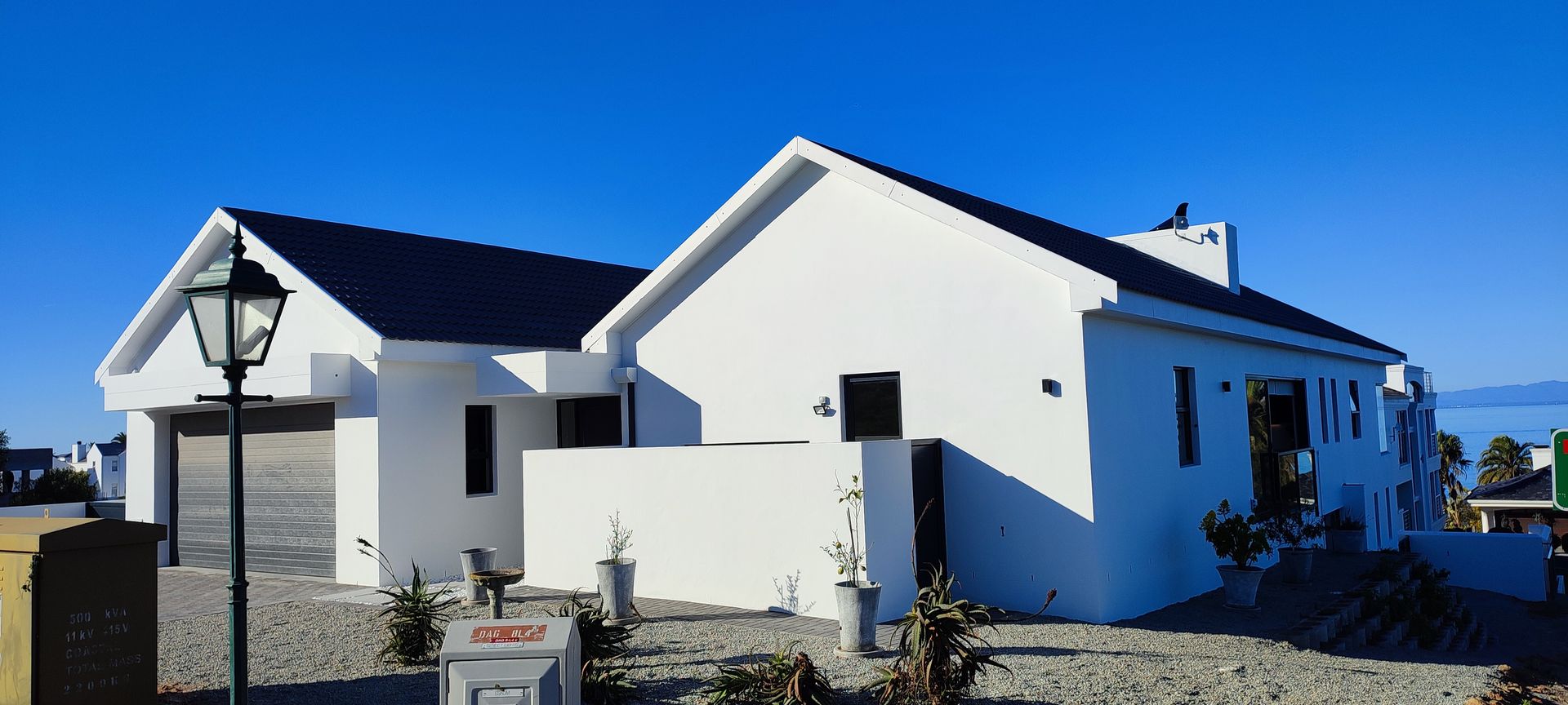 A white house with a blue sky in the background