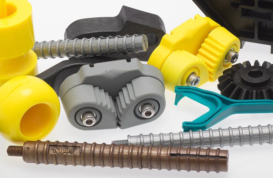 A bunch of different types of plastic parts on a white surface