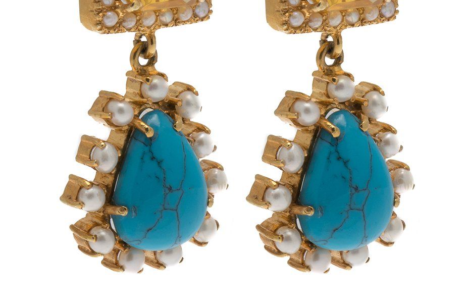 A pair of gold earrings with turquoise and pearls