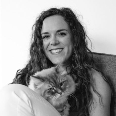 A man and a woman are posing for a picture in front of a wall that says bni