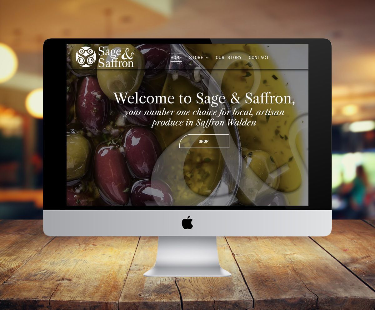 A computer monitor displays the website for sage & saffron