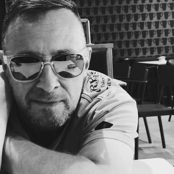 A black and white photo of a man wearing sunglasses