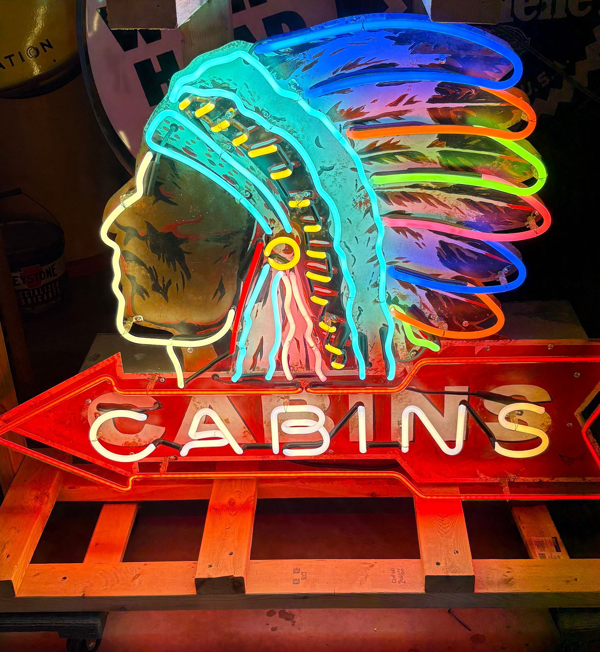 Neon sign of Native American chief headdress above 