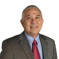 A man in a suit and tie is smiling for the camera. A man in a suit and tie is smiling for the camera.