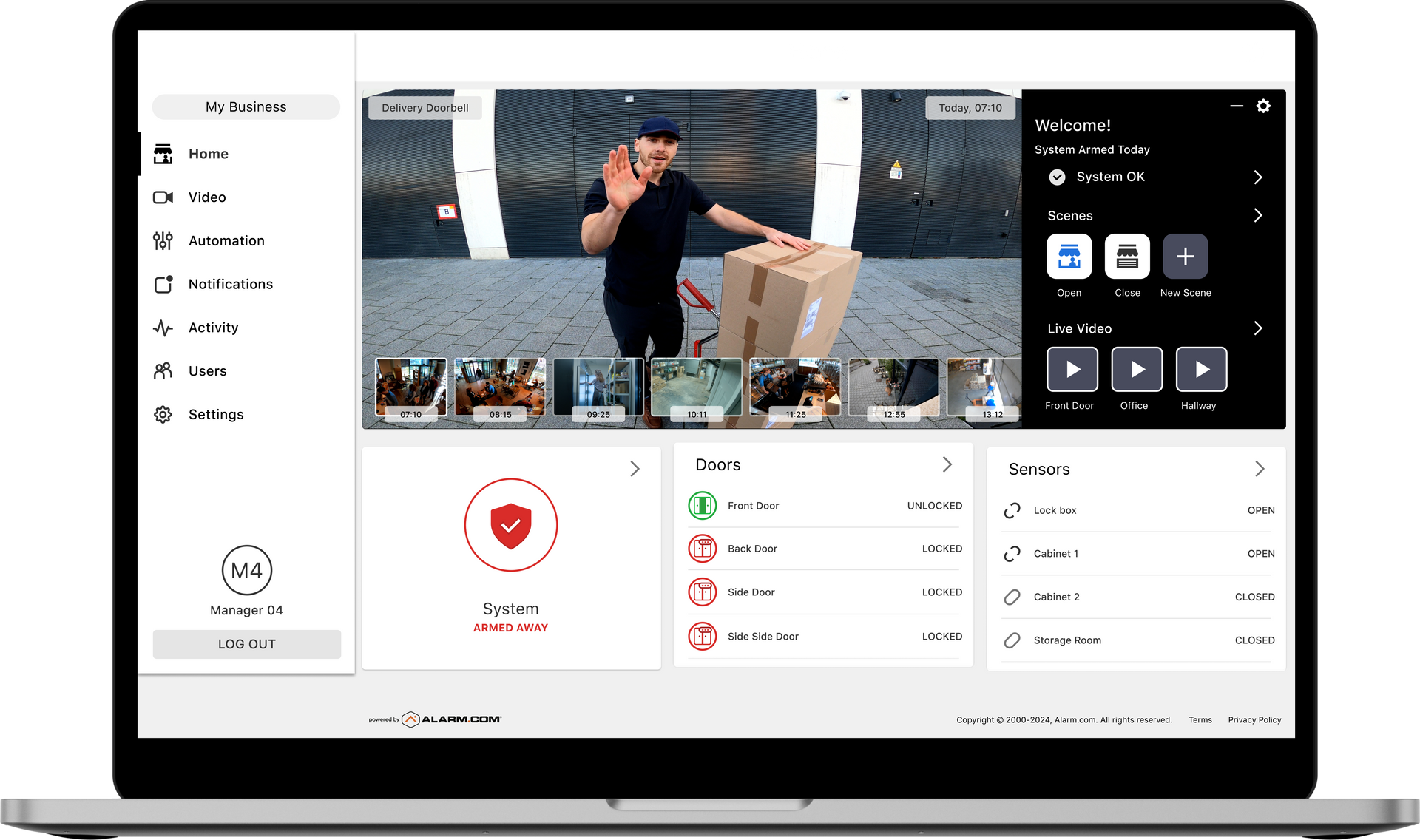 A security camera is mounted on a wall in a shopping mall.