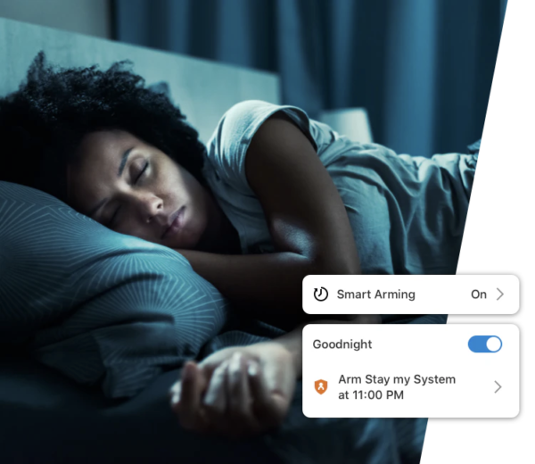 A woman is sleeping in a bed with a smart arming on