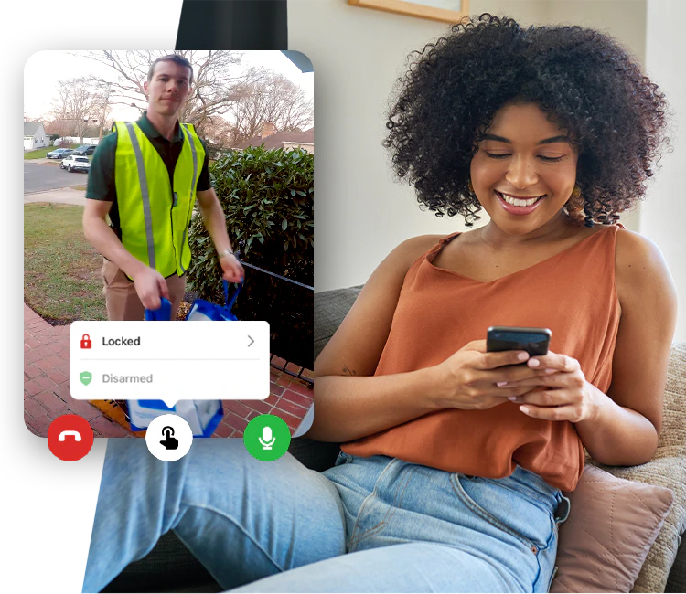 A woman is sitting on a couch talking to a man on a video call.