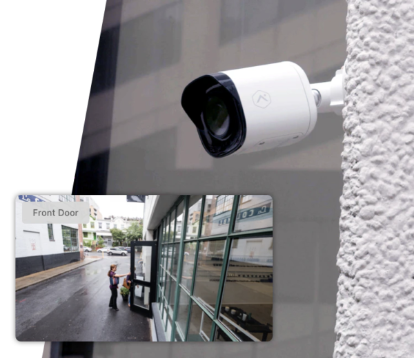 A security camera is mounted to the side of a building