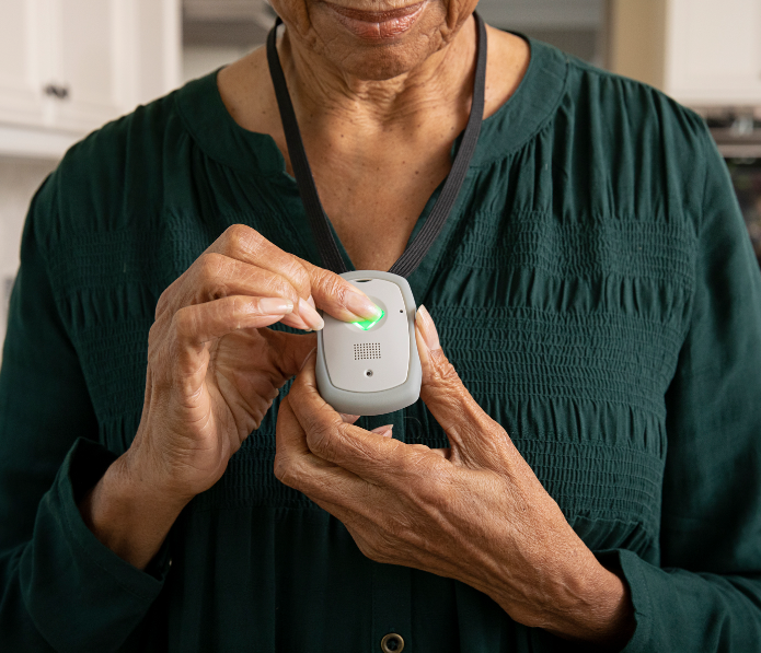 An elderly woman is holding a cell phone in her hands.