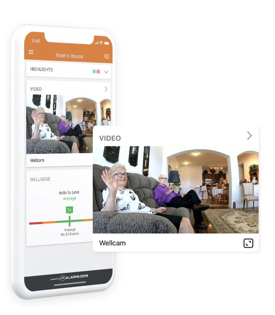A phone displays a video of an elderly couple sitting on a couch