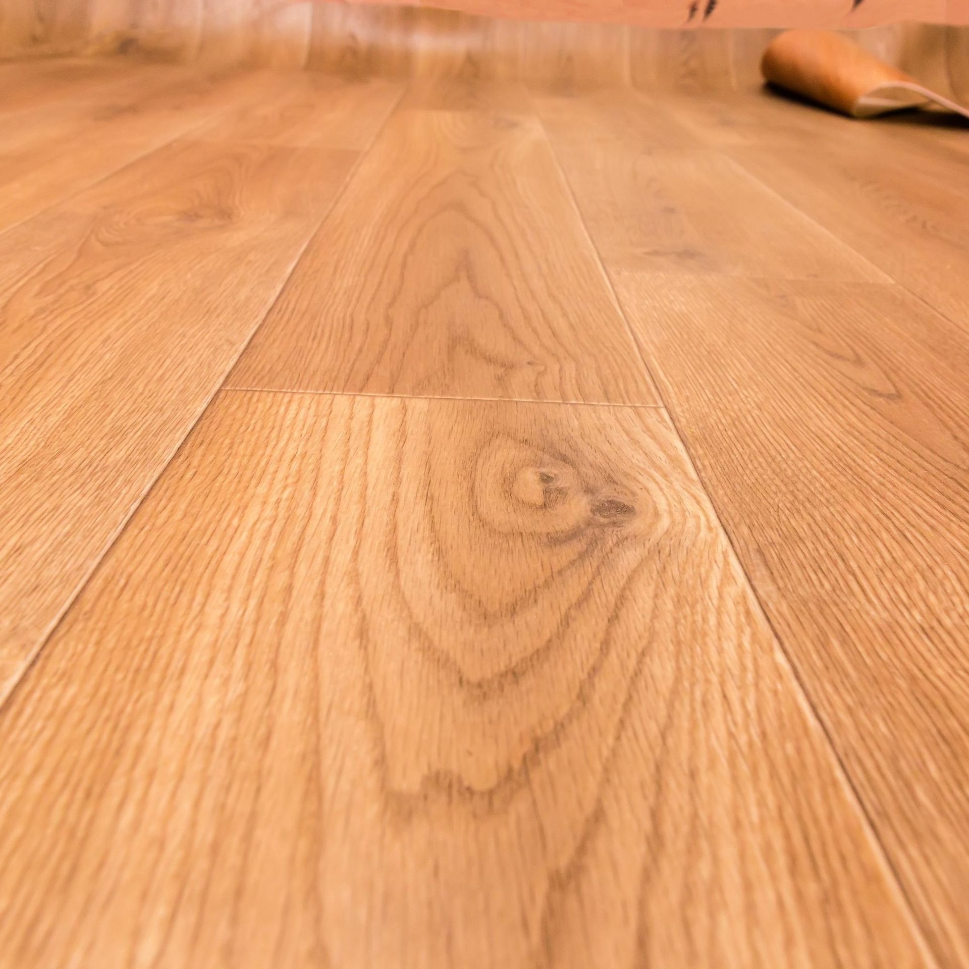 Professional Touch Carpet Upholstery Cleaning - A close up of a wooden floor with a shoe on it.