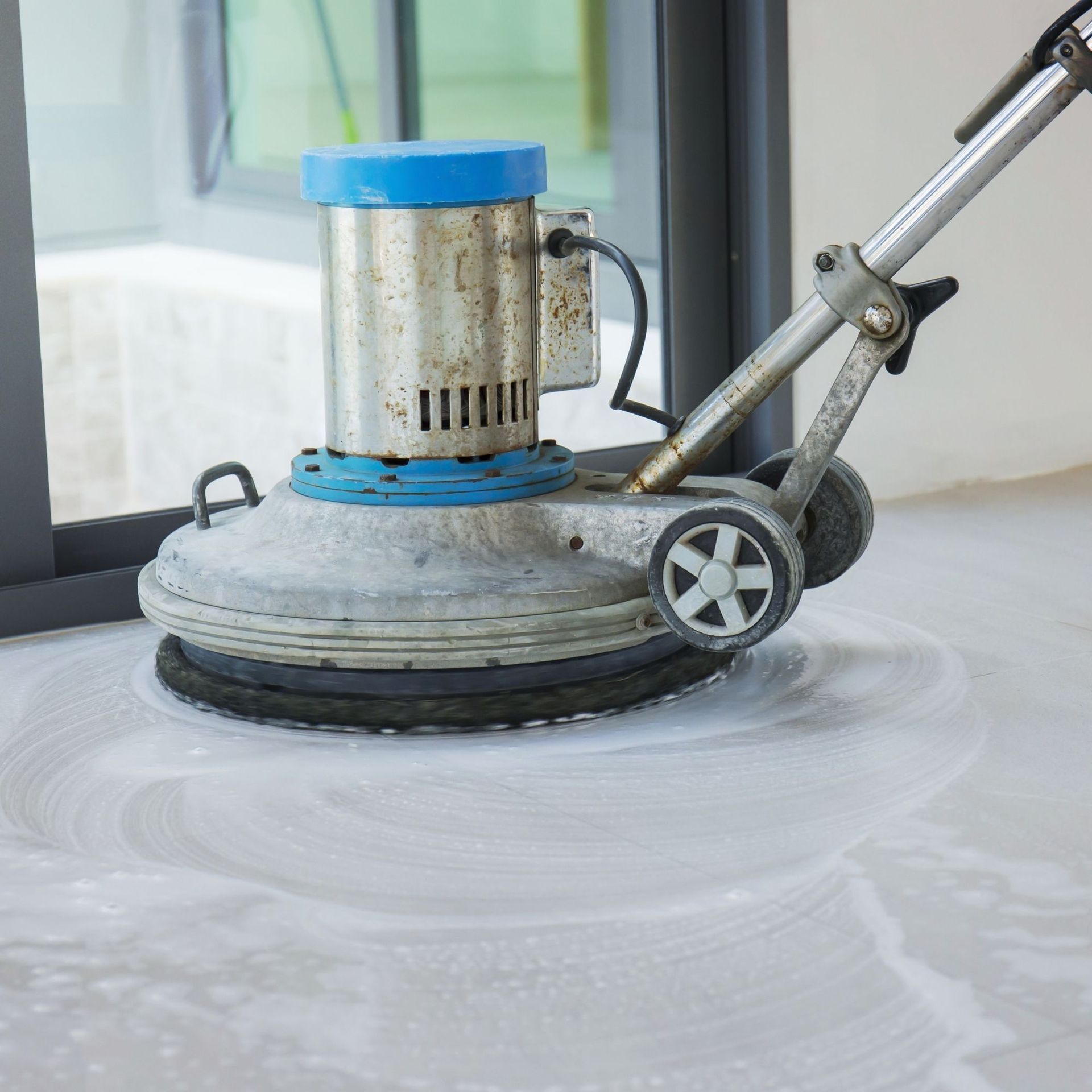 Professional Touch Carpet Upholstery Cleaning - A machine is being used to clean a concrete floor.