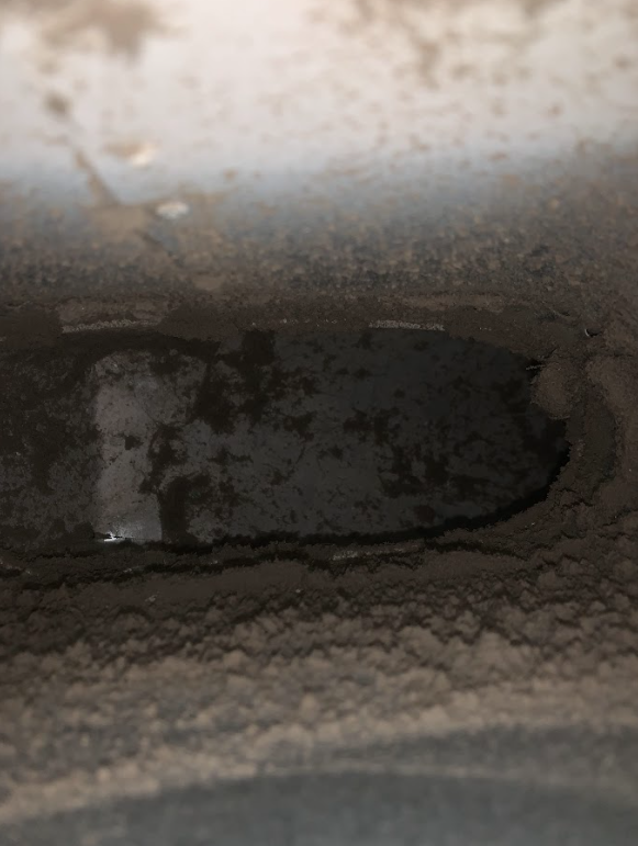 Professional Touch Carpet Upholstery Cleaning - A close up of a hole in a wall with water coming out of it.