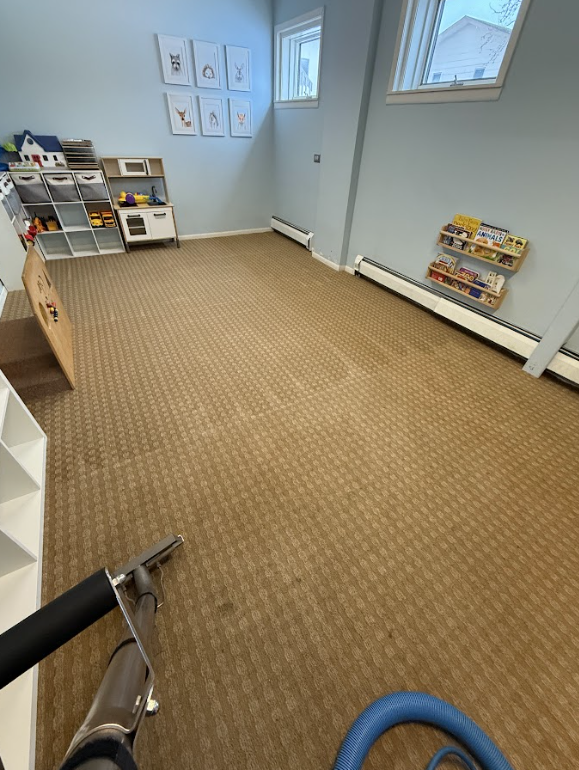 Professional Touch Carpet Upholstery Cleaning - A room with a carpeted floor and a vacuum cleaner in it.