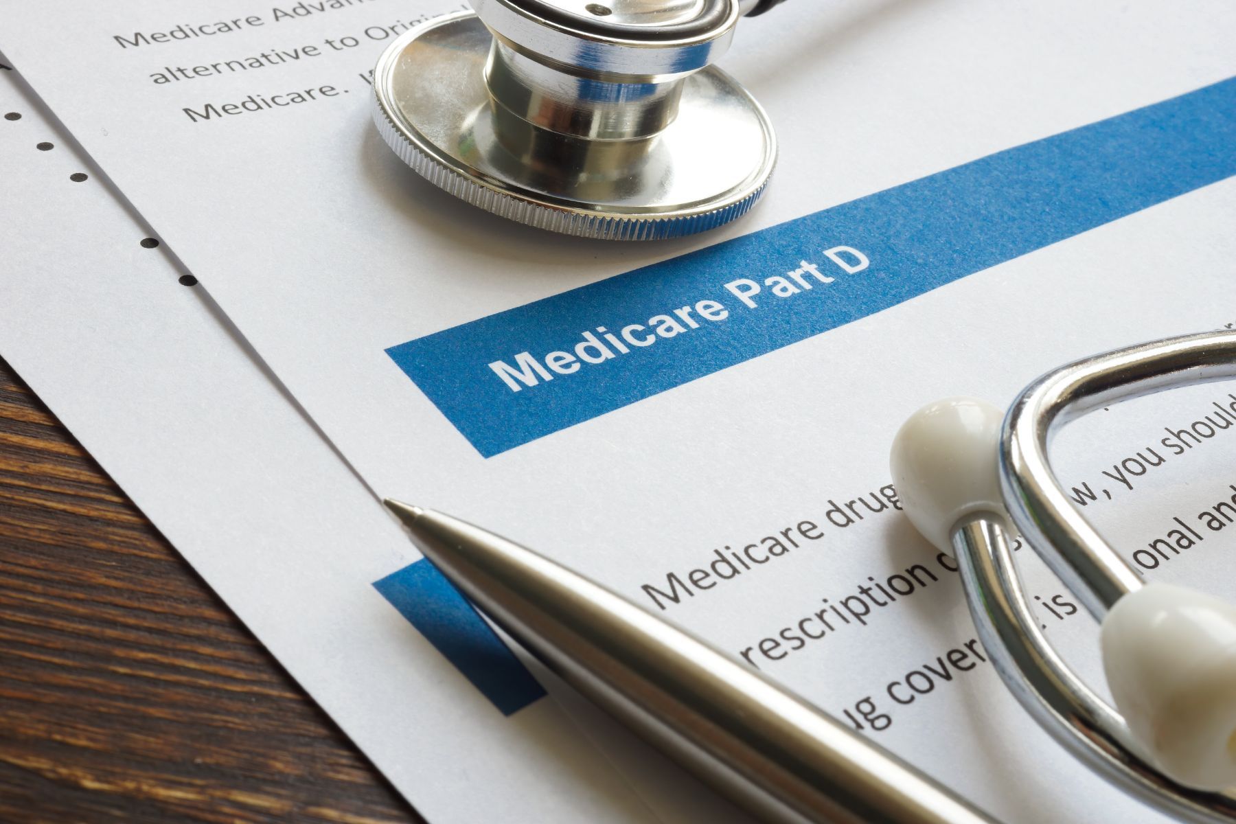 A pen and stethoscope on top of a medicare part d form