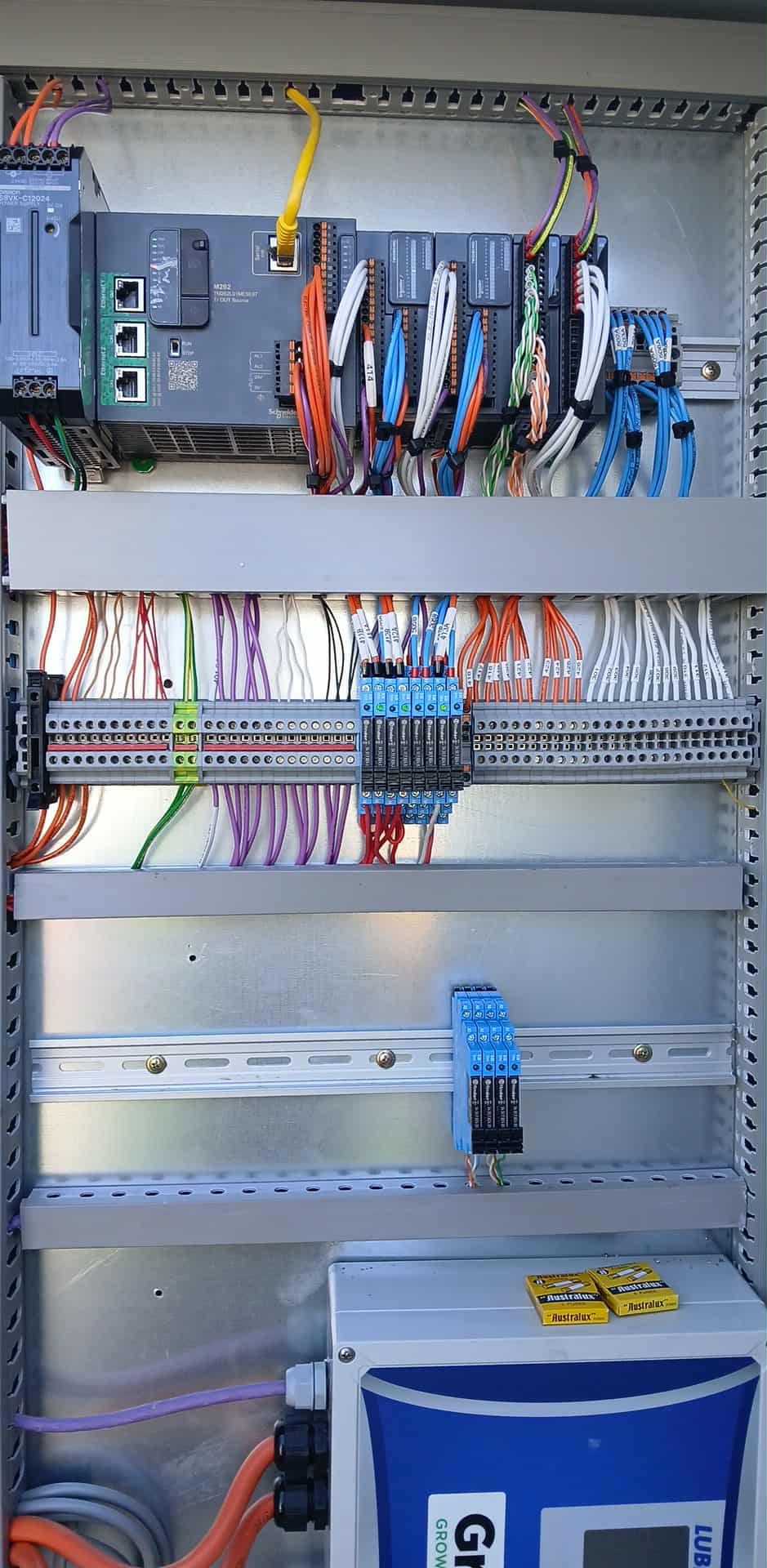 Control panel with wiring, terminals, and a blue digital display.