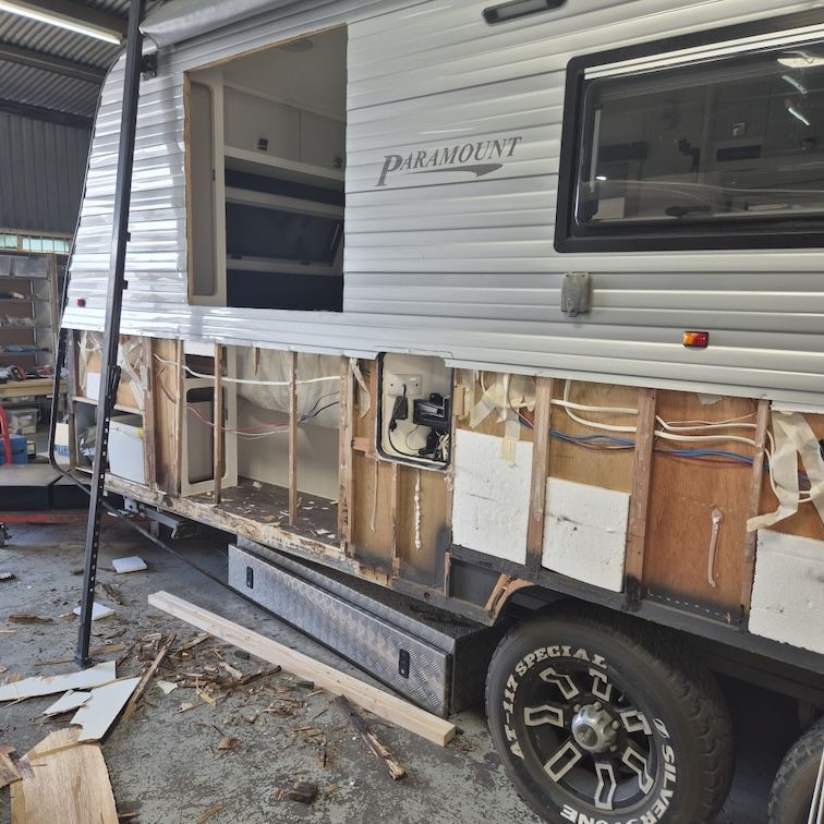 Side view of a partially disassembled caravan, revealing wooden framing and — Revive Caravan Repairs in Kippa-Ring, QLD
