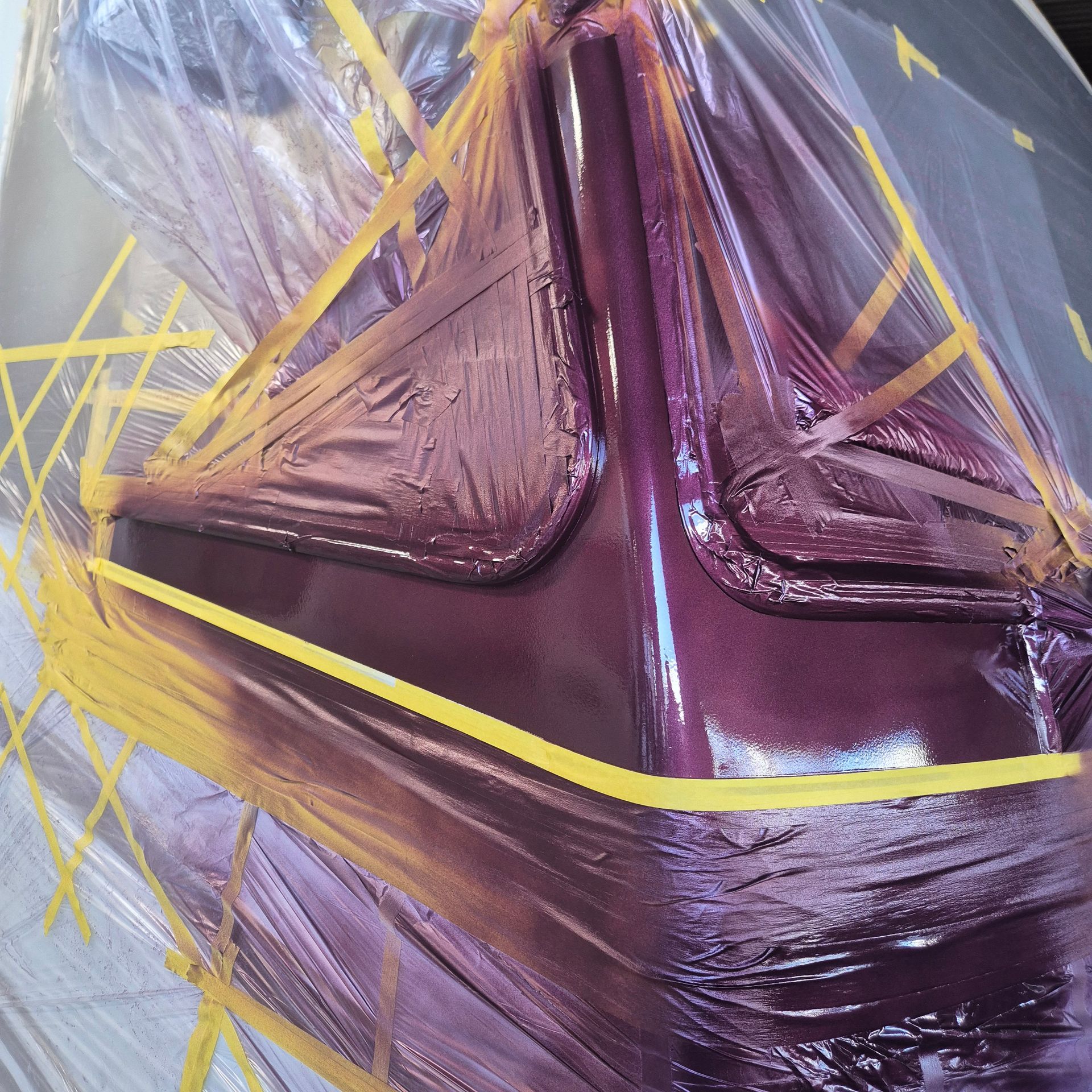 Purple Object Wrapped in Clear Plastic and Secured With Yellow Tape — Revive Caravan Repairs in Kippa-Ring, QLD