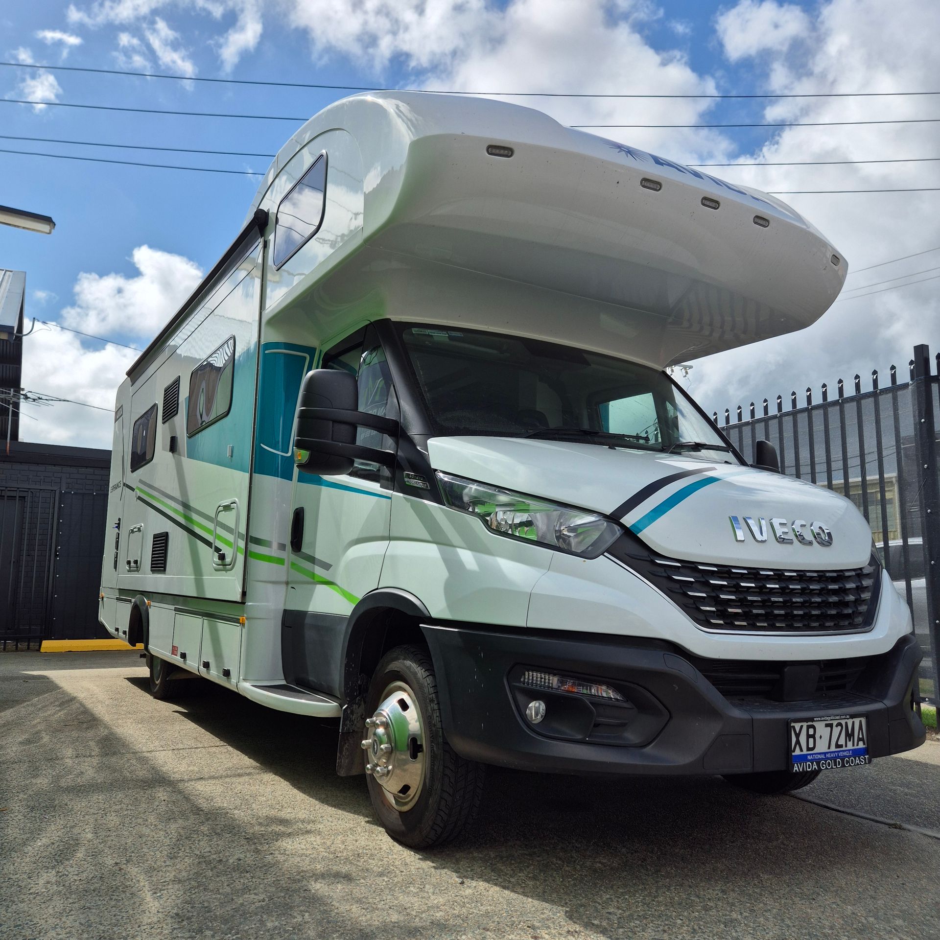 A Recreational Vehicle Parked Near a Fence — Revive Caravan Repairs in Kippa-Ring, QLD