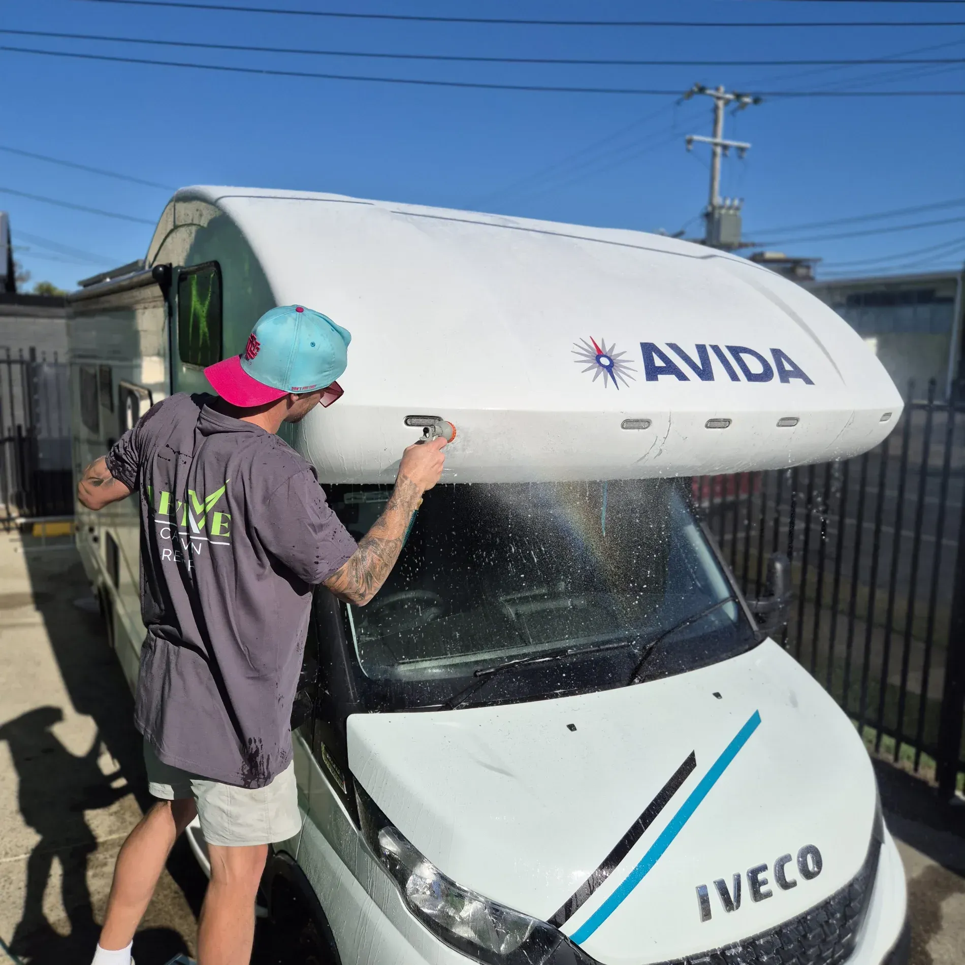 Person washing a white Avida campervan — Revive Caravan Repairs in Kippa-Ring, QLD