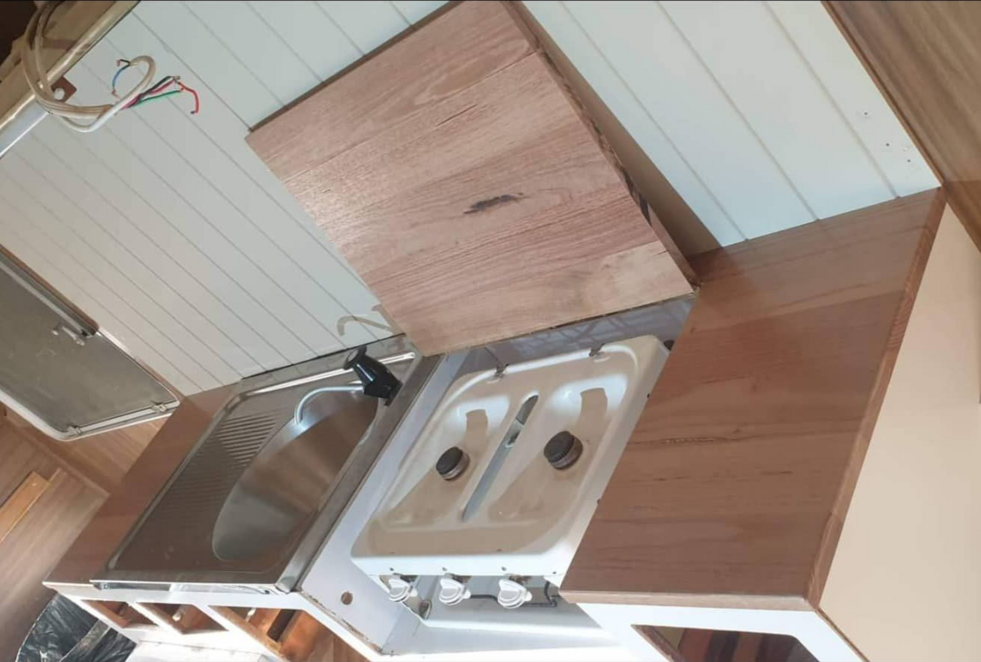 Wooden camper kitchen with sink, stove, and fold-up countertop — Revive Caravan Repairs in Kippa-Ring, QLD