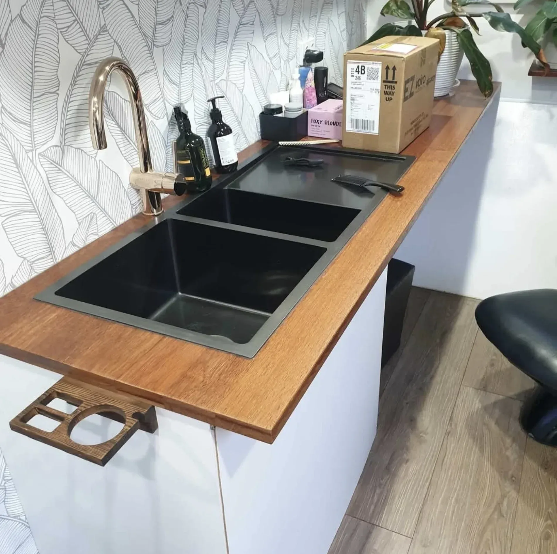 A salon sink with gold faucet, black basins, wood counter, and white cabinets — Revive Caravan Repairs in Kippa-Ring, QLD