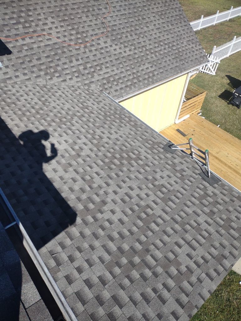 Man Taking Picture of Roof — Pelham, AL — Supreme Roofing & Renovations