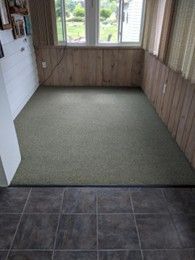 A room inside a house with wooden walls, with a recently installed carpet flooring. A room inside a house with wooden walls, with a recently installed carpet flooring.