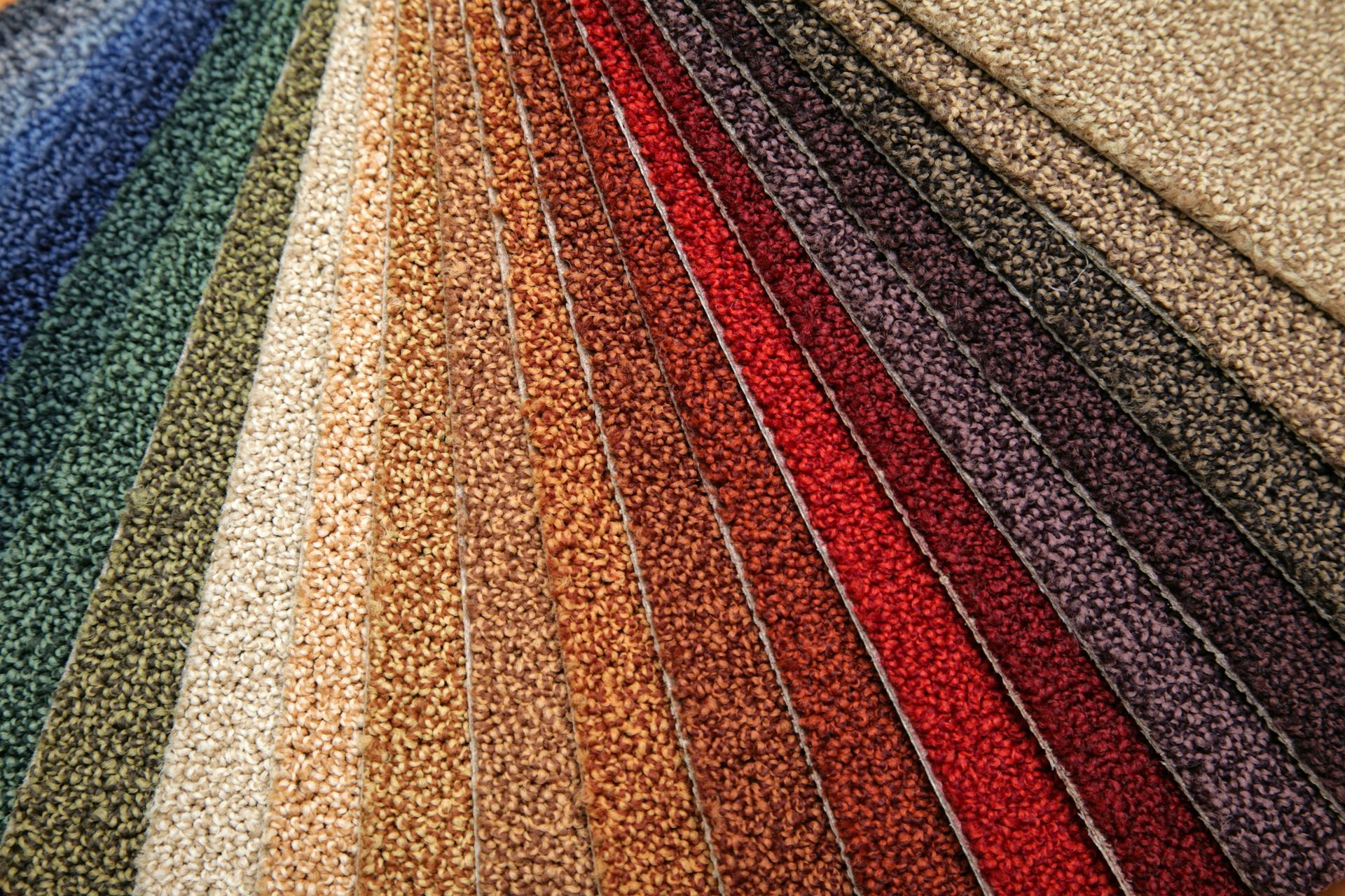 Colorful carpet samples in various textures and shades for flooring design options.