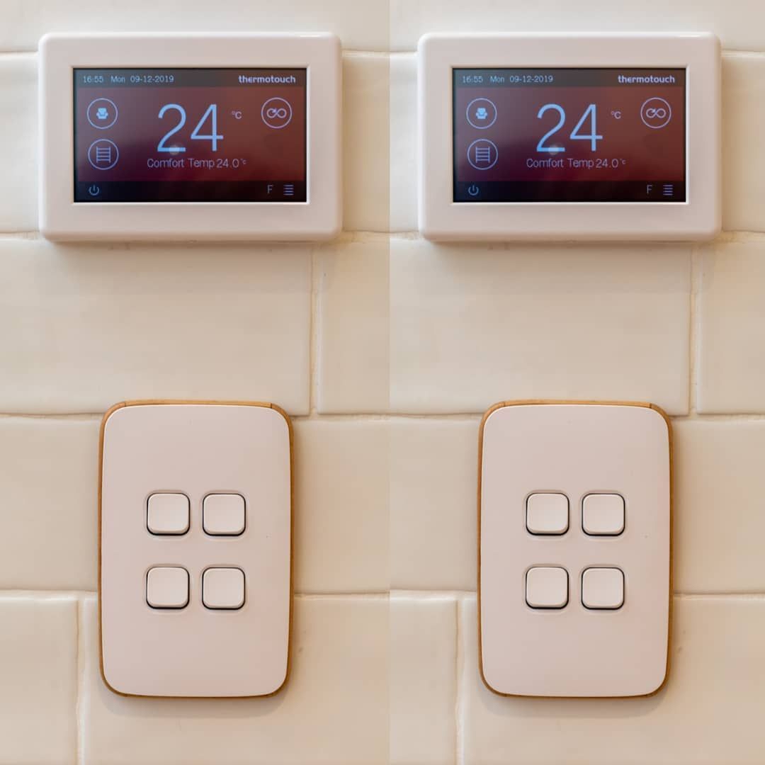 Two Thermostats Are Mounted On A Tiled Wall And The Temperature Is 24 Degrees — Electrician In Wagga Wagga, NSW