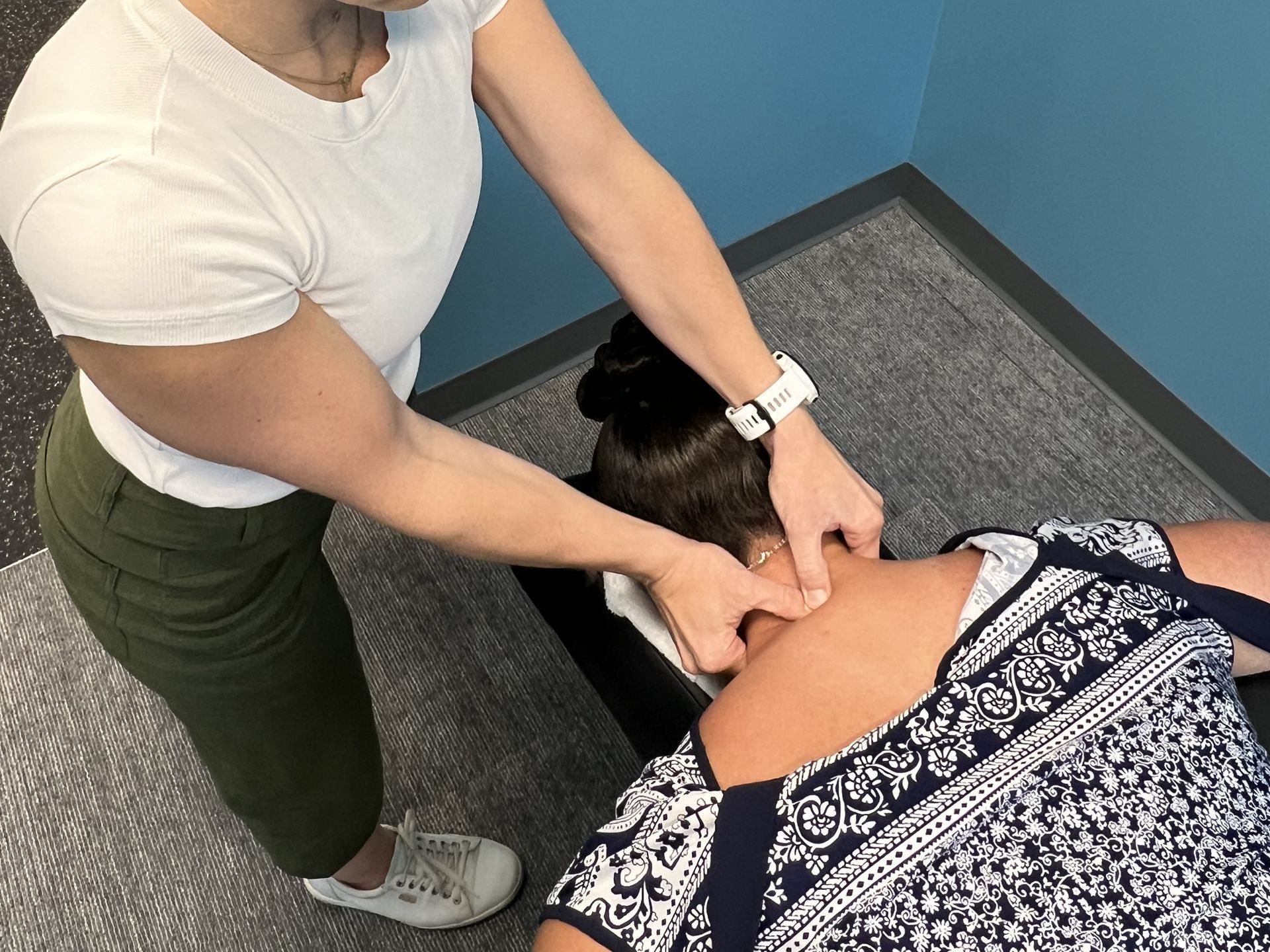 A woman is giving a massage to another woman