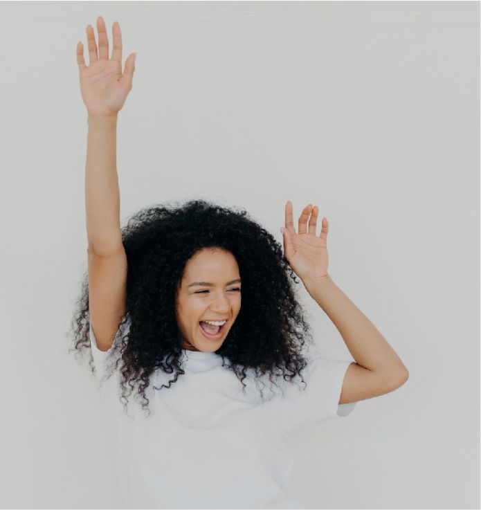 A Happy Woman With Curly Hair — Hyde Burchell Buyers Agents In Canberra, A
