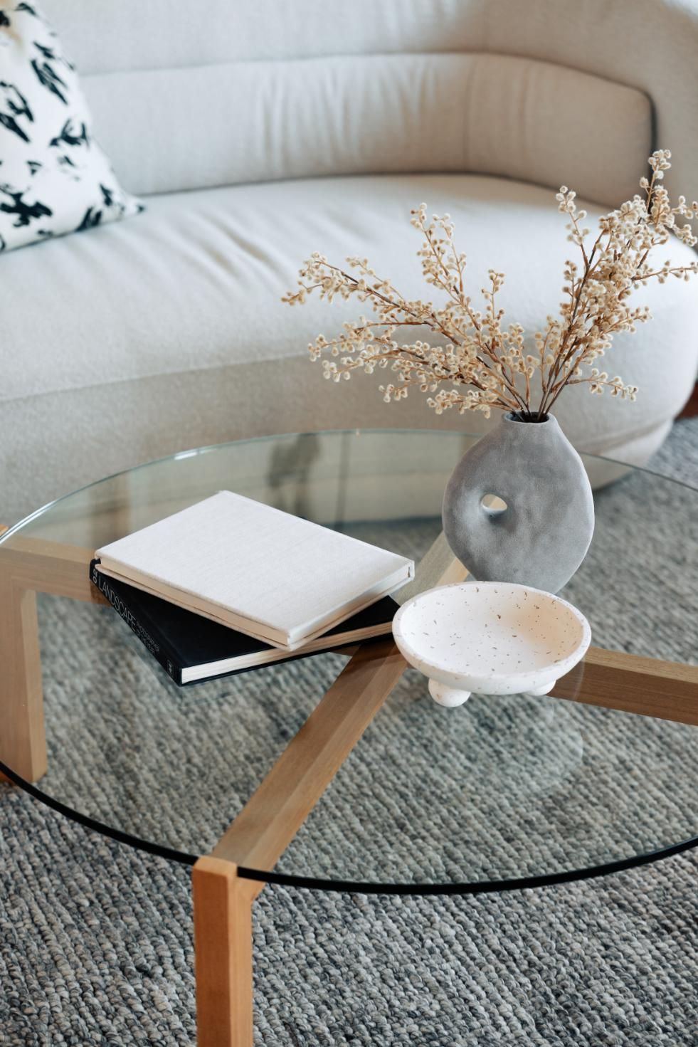 Glass Coffee Table With Decorative Items on Top — Hyde Burchell Buyers Agents In Canberra, ACT