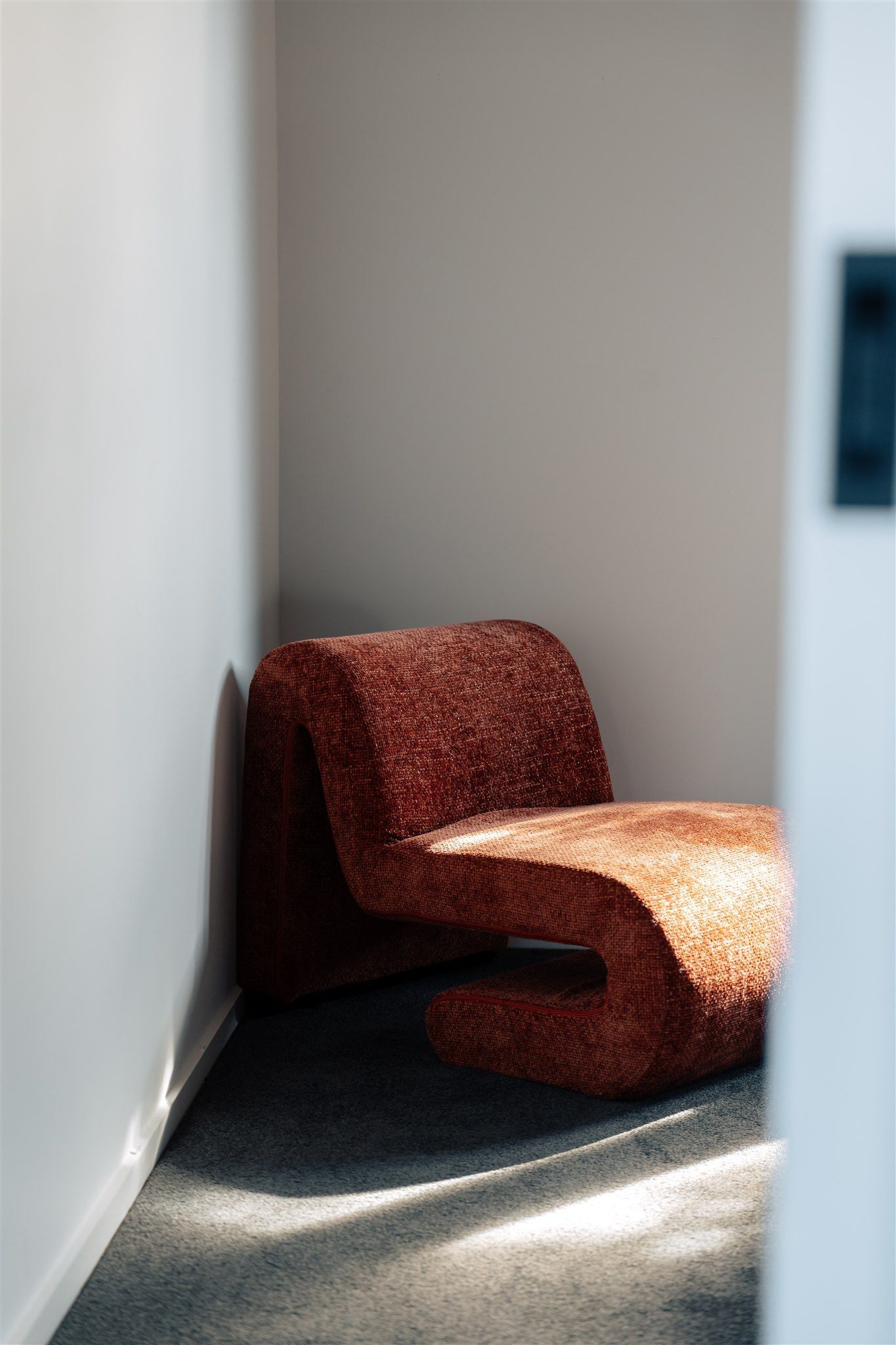 An orange couch has sunlight streaming onto it — Hyde Burchell Buyers Agents In Canberra, ACT