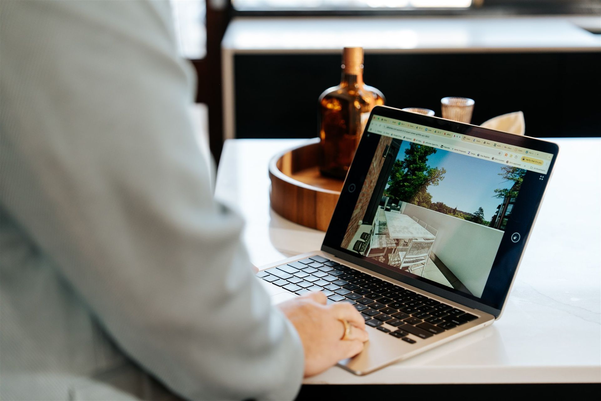 Man's arm and hand typing on a laptop — Hyde Burchell Buyers Agents In Canberra, ACT