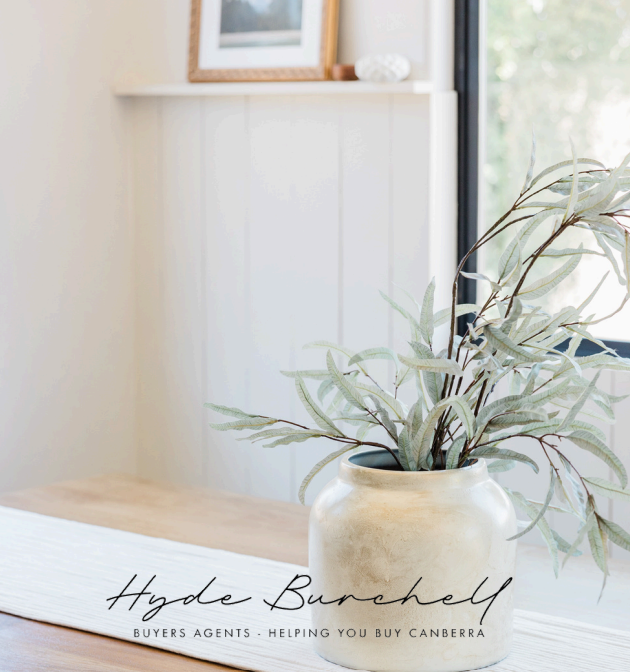A Vase With a Plant in It Sits on a Table Next to a Window — Hyde Burchell Buyers Agents In Canberra, ACT
