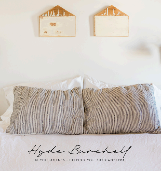 A Bed With Two Pillows and a Sign That Says Hyde Burchell — Hyde Burchell Buyers Agents In Canberra, ACT
