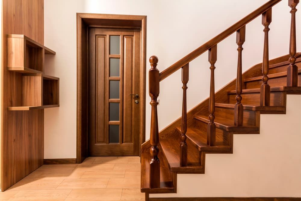 Wooden Staircase With Polished Banister on the Right Leads Up