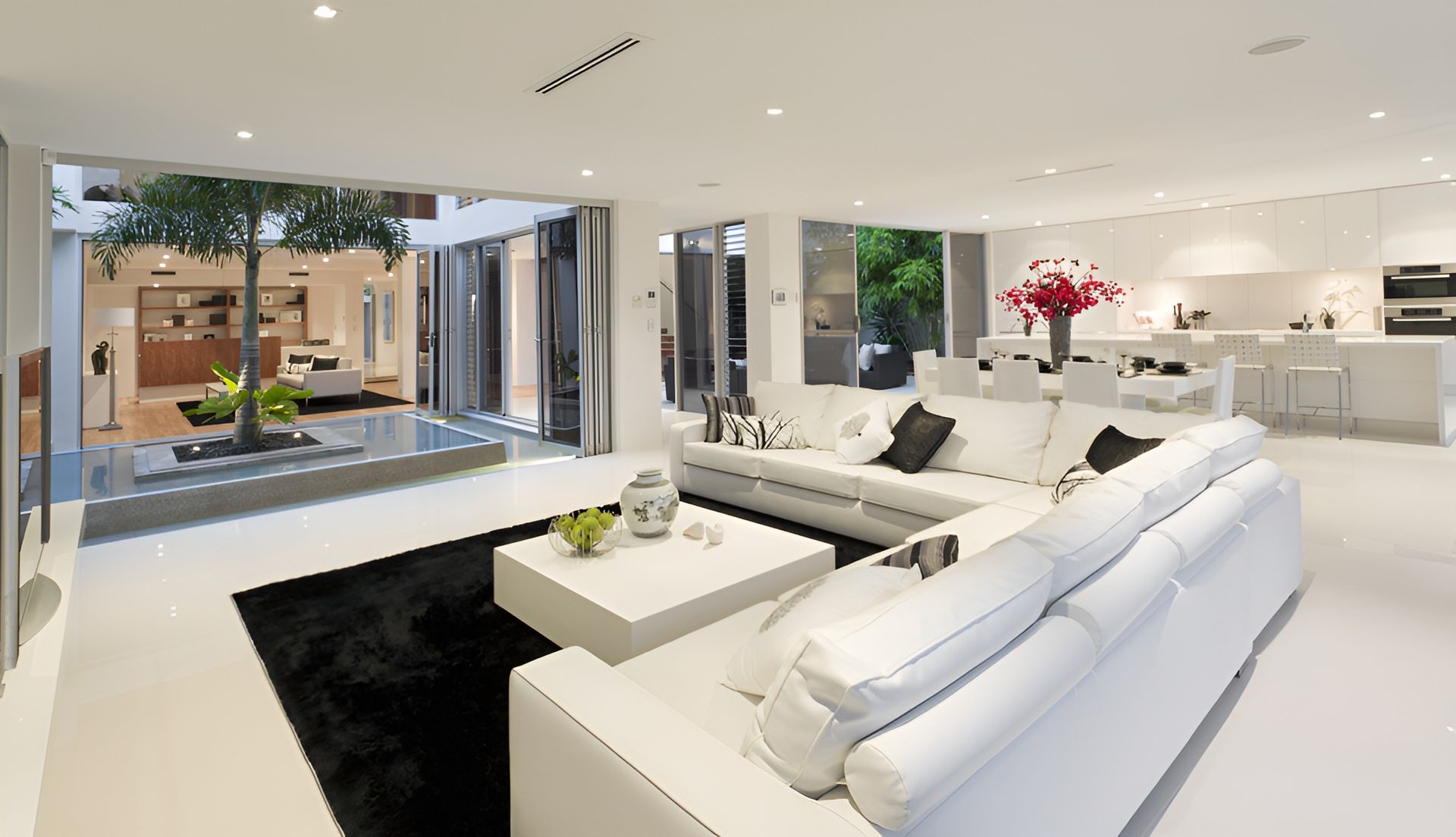 Modern, White Living Room with a Large, White Sectional Sofa — Hyde Burchell Buyers Agents In Canberra, ACT
