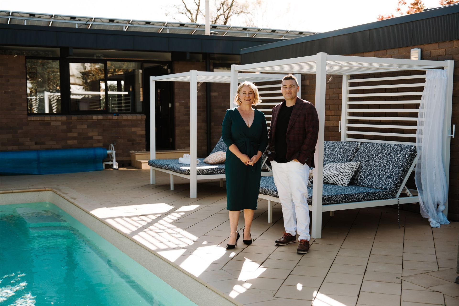 A Man and a Woman Are Sitting on the Floor in Front of a Window — Hyde Burchell Buyers Agents In Canberra, ACT