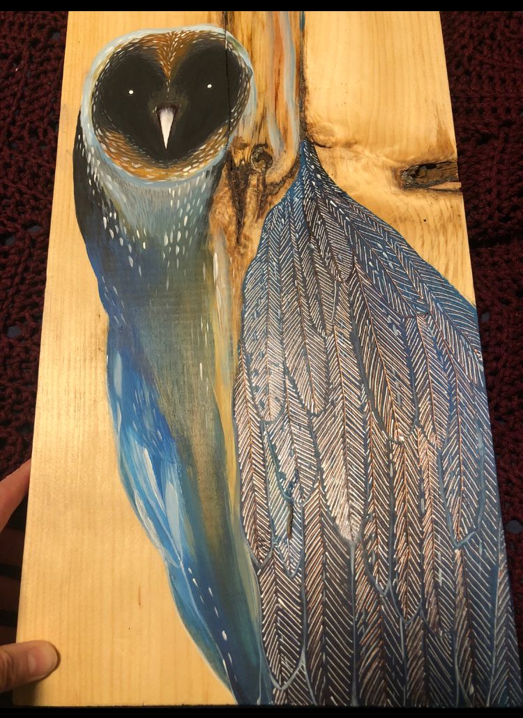 Painting of an owl with a face as dark as the night sky and a body of blue feathers and wood grain melting into  that body from above.