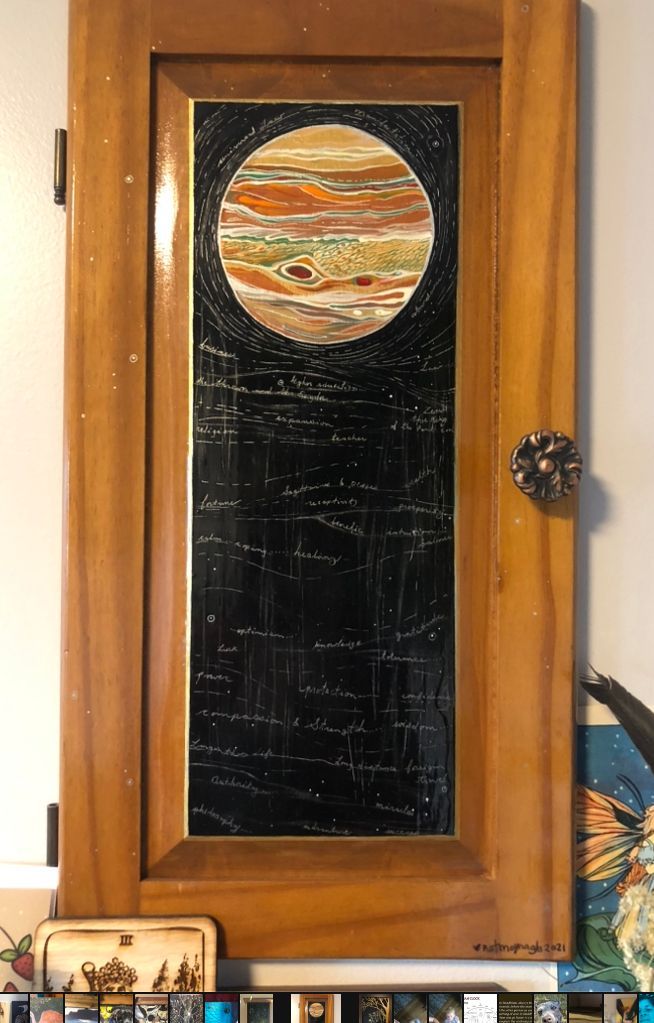 Painting of the planet Jupiter with orange and yellow hues and words written on a black background that describe the archetype and characteristics we've attributed to the planet as humans in forming a deeper relationship with these celestial beings. Words such as: wisdom, law, generosity, expansive, lucky etc.