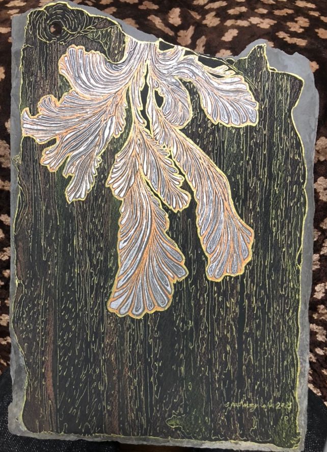 A funky mushroom drawn on slate in gell pen, pencil crayons, with a black background and gold rain dripping down.