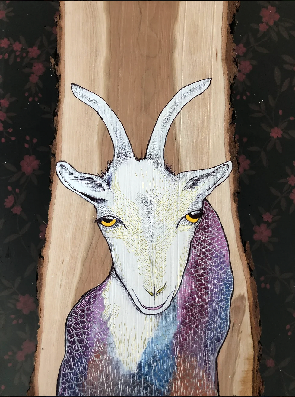 Painting of a sea goat inspired by the astrological sign of Capricorn, a young goat with yellow eyes and a multi coloured fish body, with hues of purple and blue.