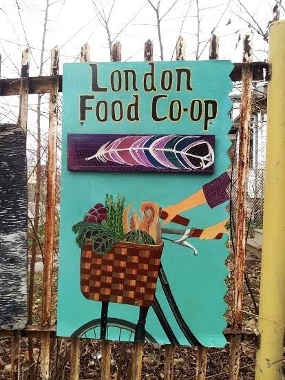 Painting of a bike and basket with food overflowing from the London food co-op with those same words printed above.