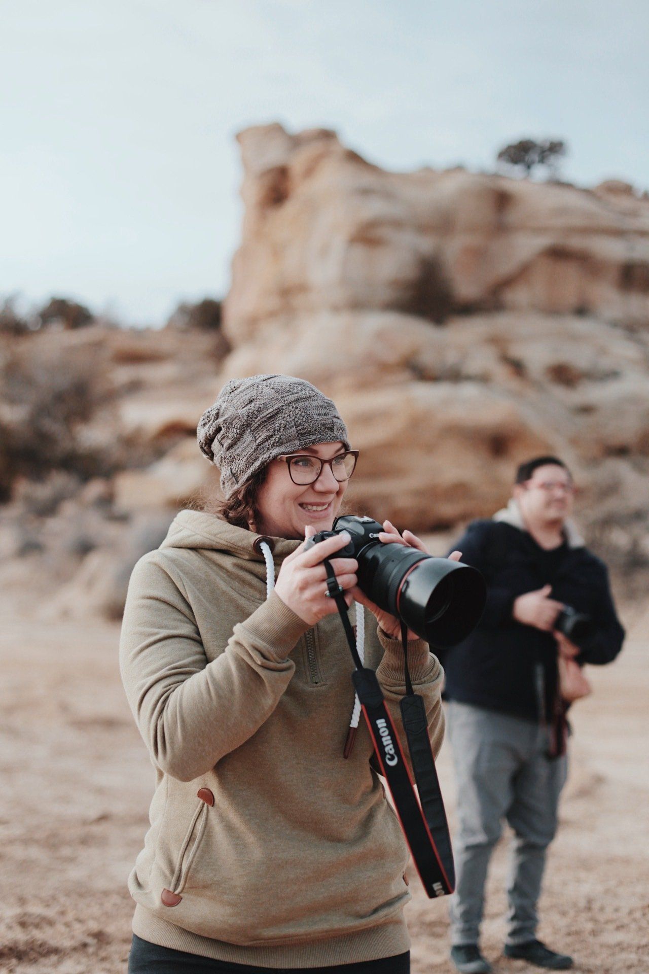 Britanny photographer from Zia Media Group is taking a picture with a camera in the desert.