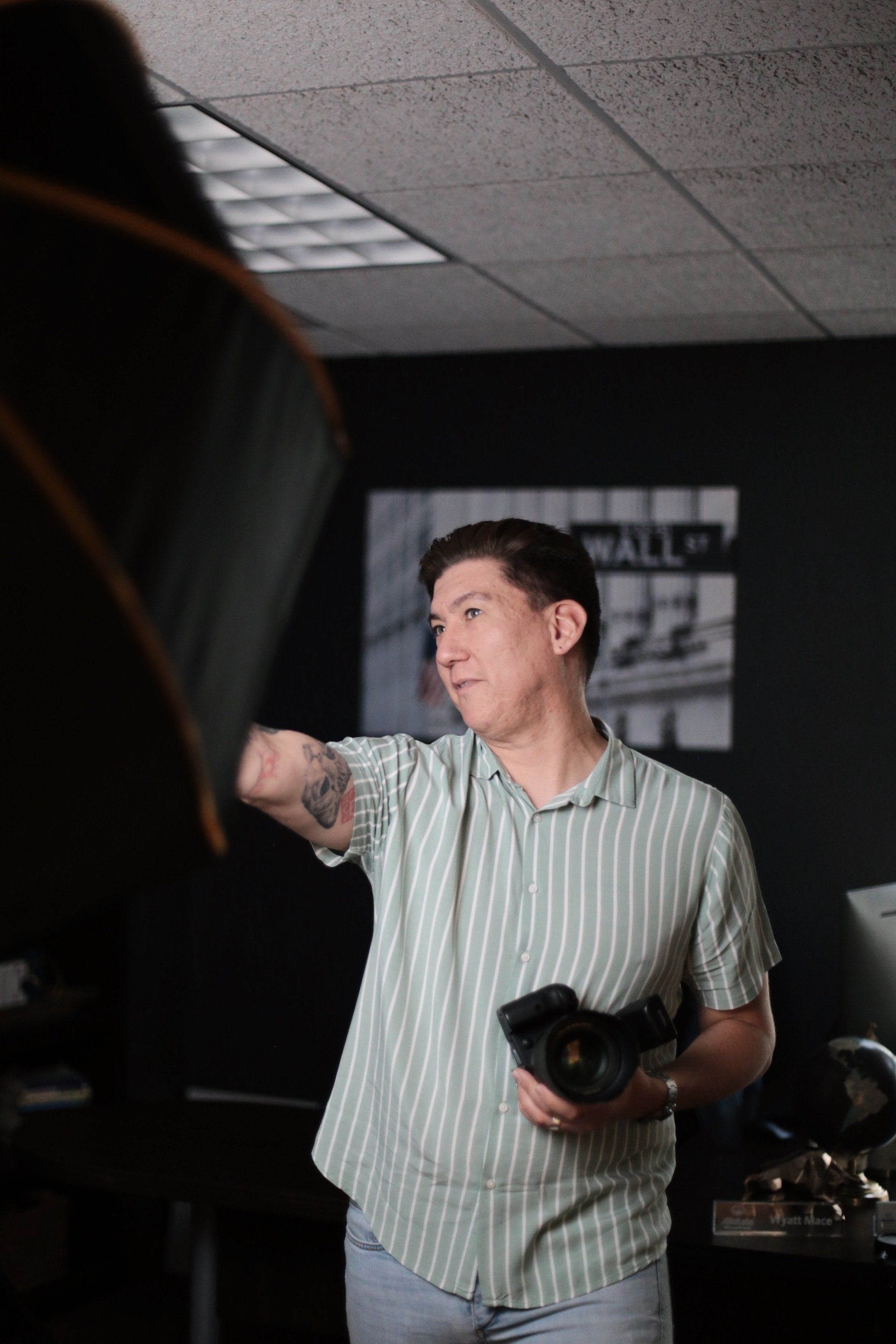 Johnathan Sifford setting up lighting for a studio shoot